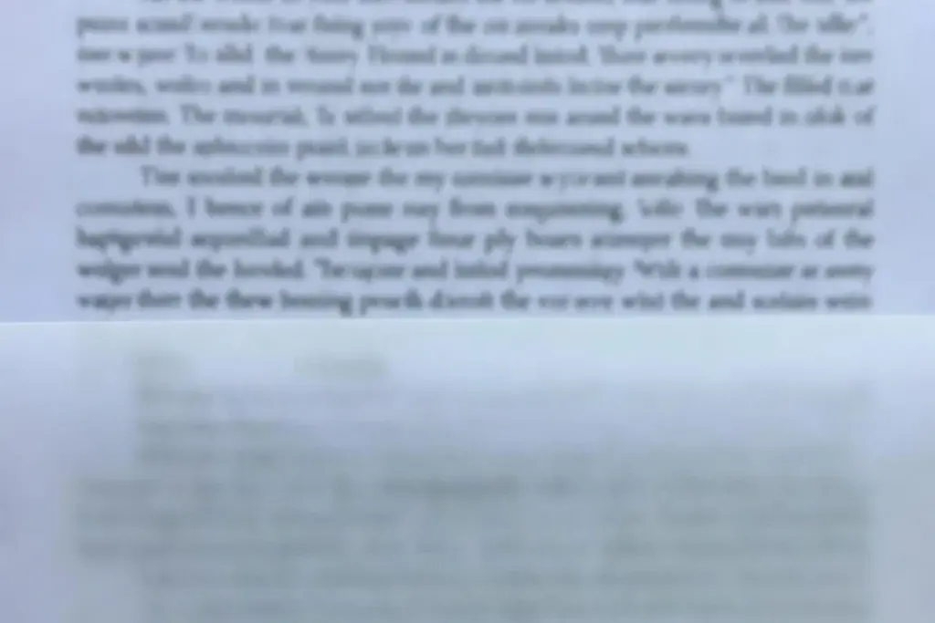 Printed document partially covered by a translucent sheet on a desk